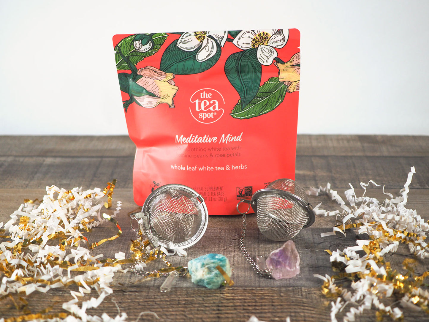 Meditative Mind Tea shown with 2 tea strainers with crystals attached
