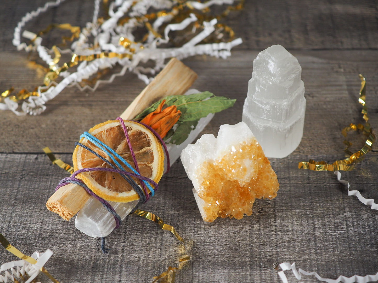 A Satin Spar Selenite Tiny Skyscraper, a Citrine cluster, and a Citrus, Palo Santo, and Satin Spar Selenite Bundle