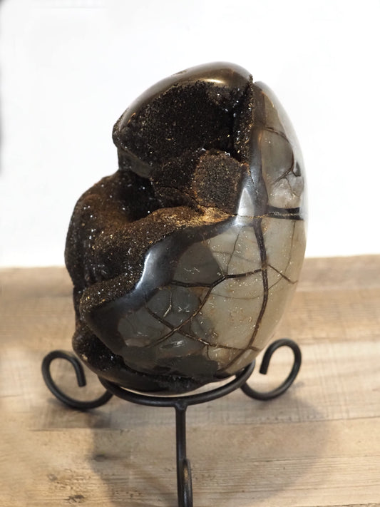 XL 7.25" tall Septarian Dragon Egg with Black Druzy, shown on its included wrought iron stand