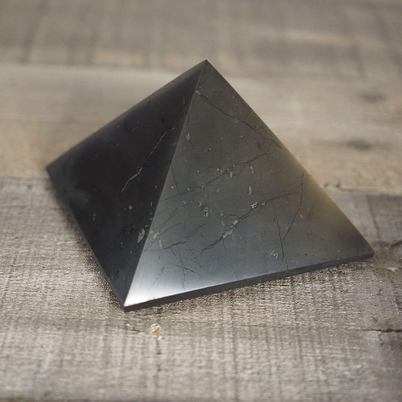 Deep black Shungite pyramid that is about 3" square at the base