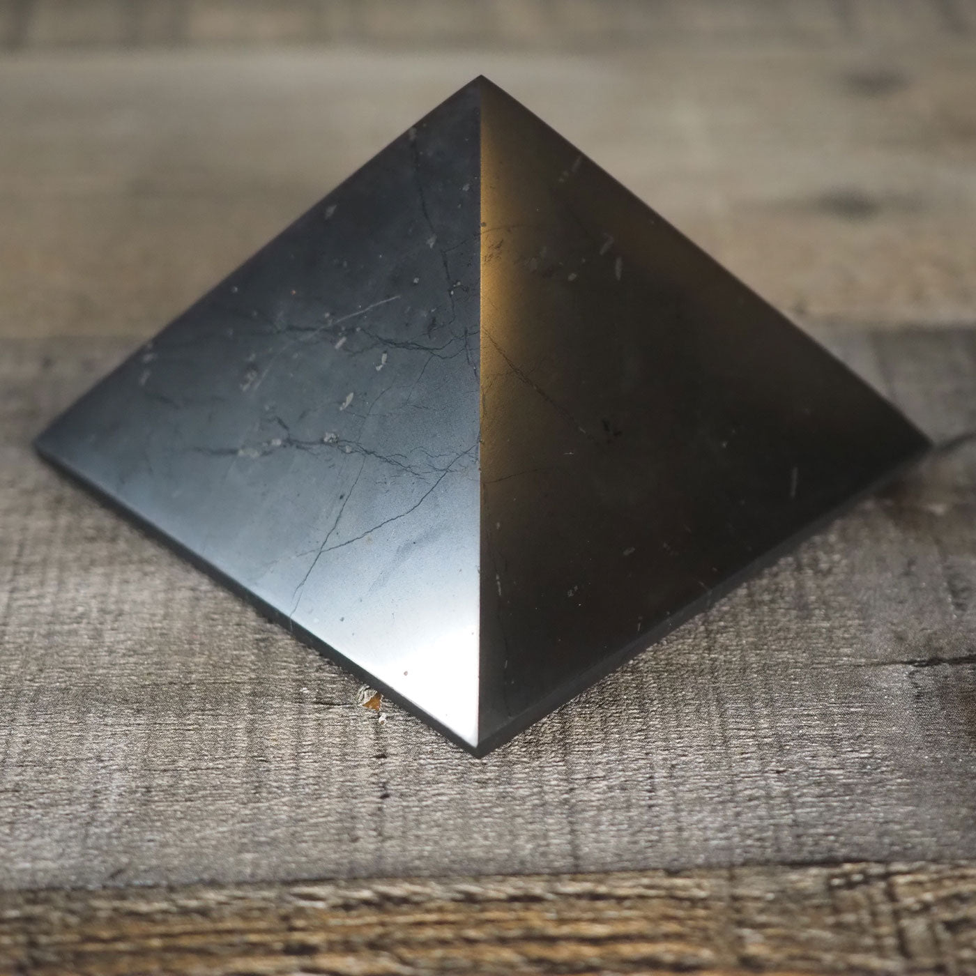 Deep black Shungite pyramid that is about 3" square at the base