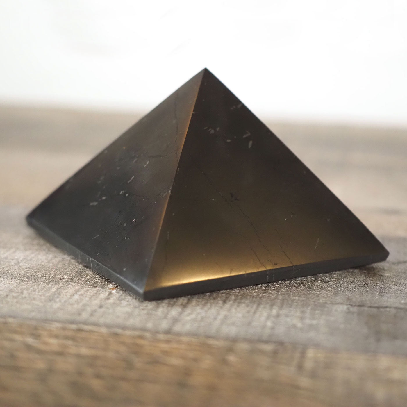 Deep black Shungite pyramid that is about 3" square at the base