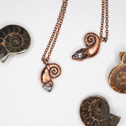 2 copper nautilus-shaped pendants with a herkimer diamond, on a copper chain