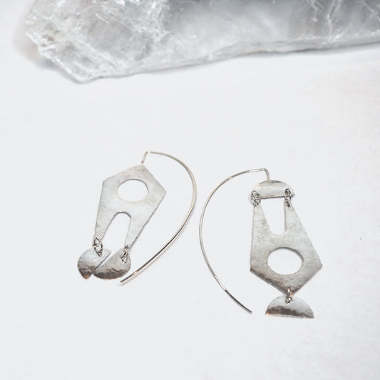 Hammered sterling silver large dangle earrings featuring stylized rocket ships