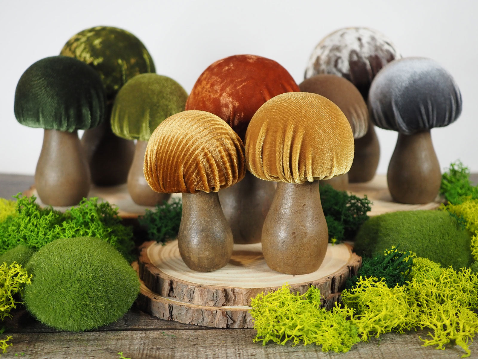 9 hand-made decorative mushrooms with different shades of velvet tops and wooden bases