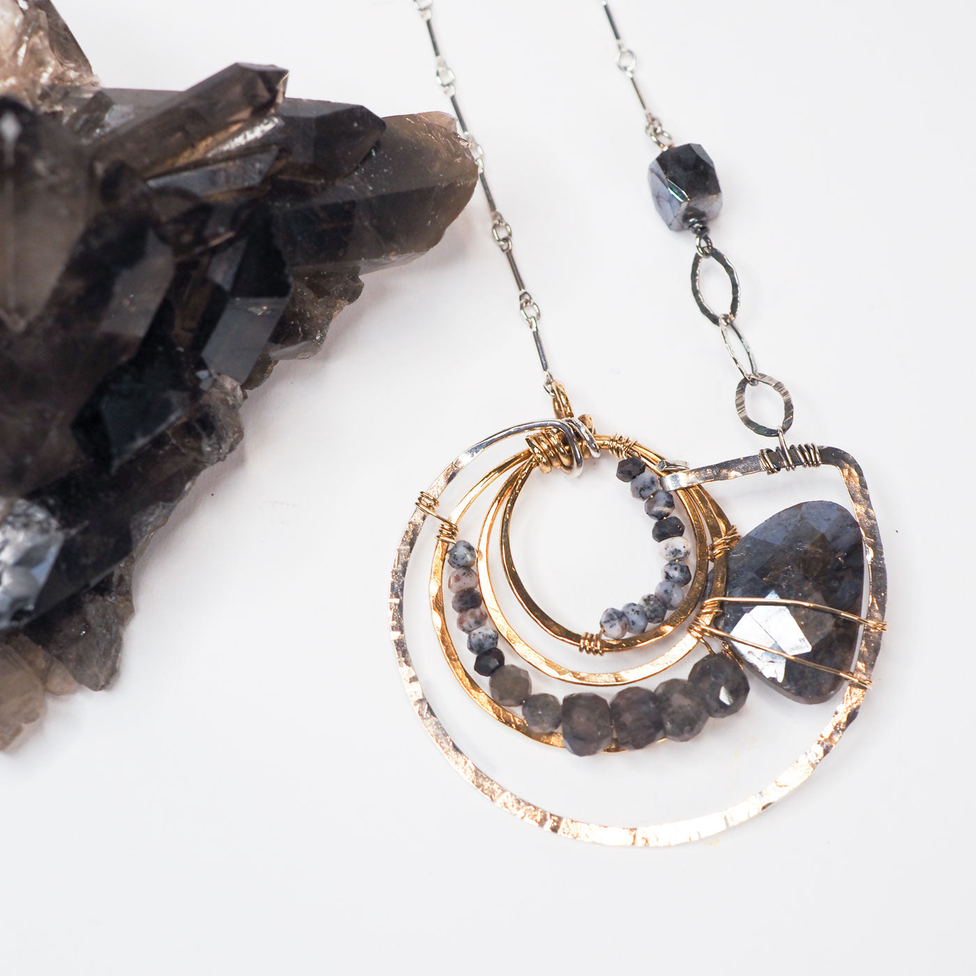Dendritic opal and faceted labradorite beads swirl into a labradorite luster drop in a nod to the the ancient ammonite in this hand-formed sterling silver statement necklace!