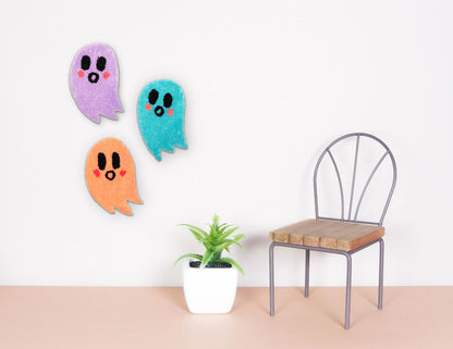 Three multi-colored ghost hand-tufted wall hangings