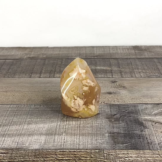 This sculpted flower agate flame is a little over 3" tall and 2.25" wide at its base. - Video