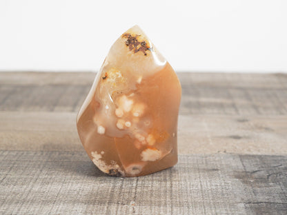 This sculpted flower agate flame is a little over 3" tall and 2.25" wide at its base.