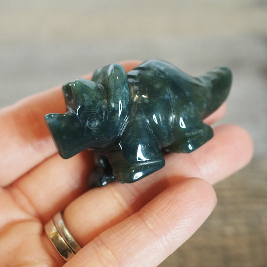 2" Moss Agate Triceratops Carving in a hand