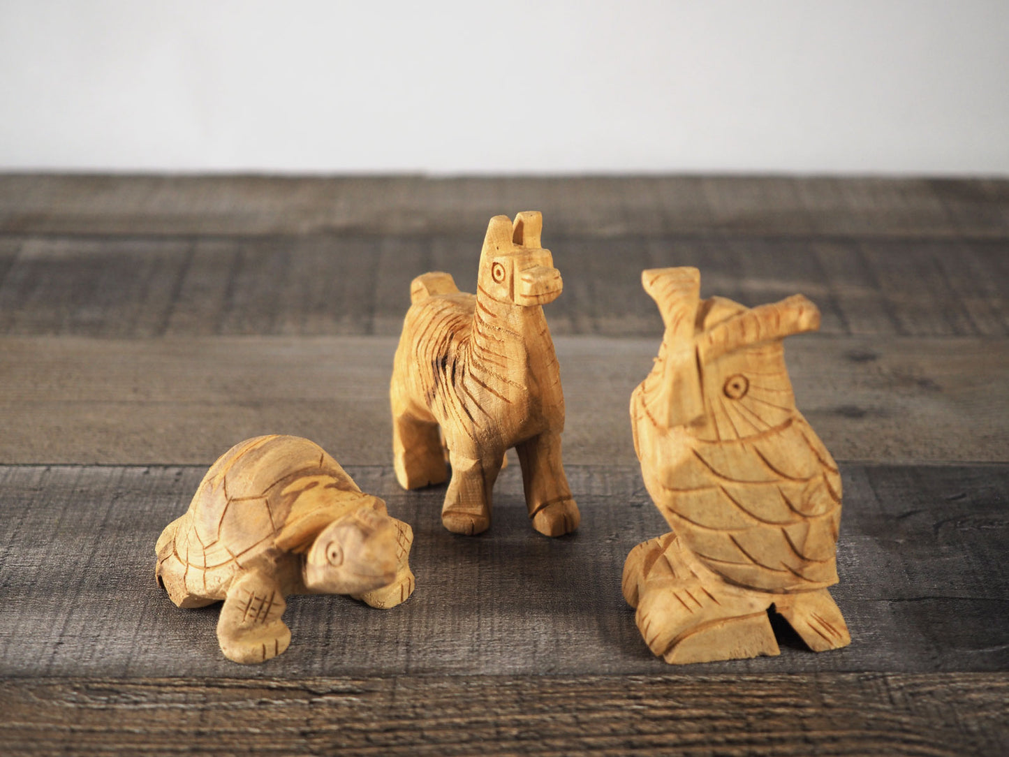 Wood carvings made from Palo Santo - a turtle, an alpaca, and an owl