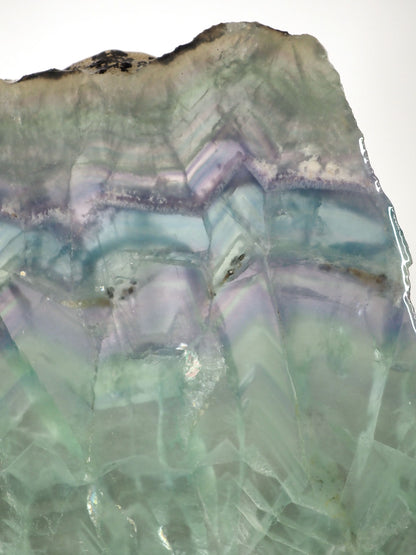 7" x 7" pastel Rainbow Fluorite slab sitting on included white metal stand - Closeup