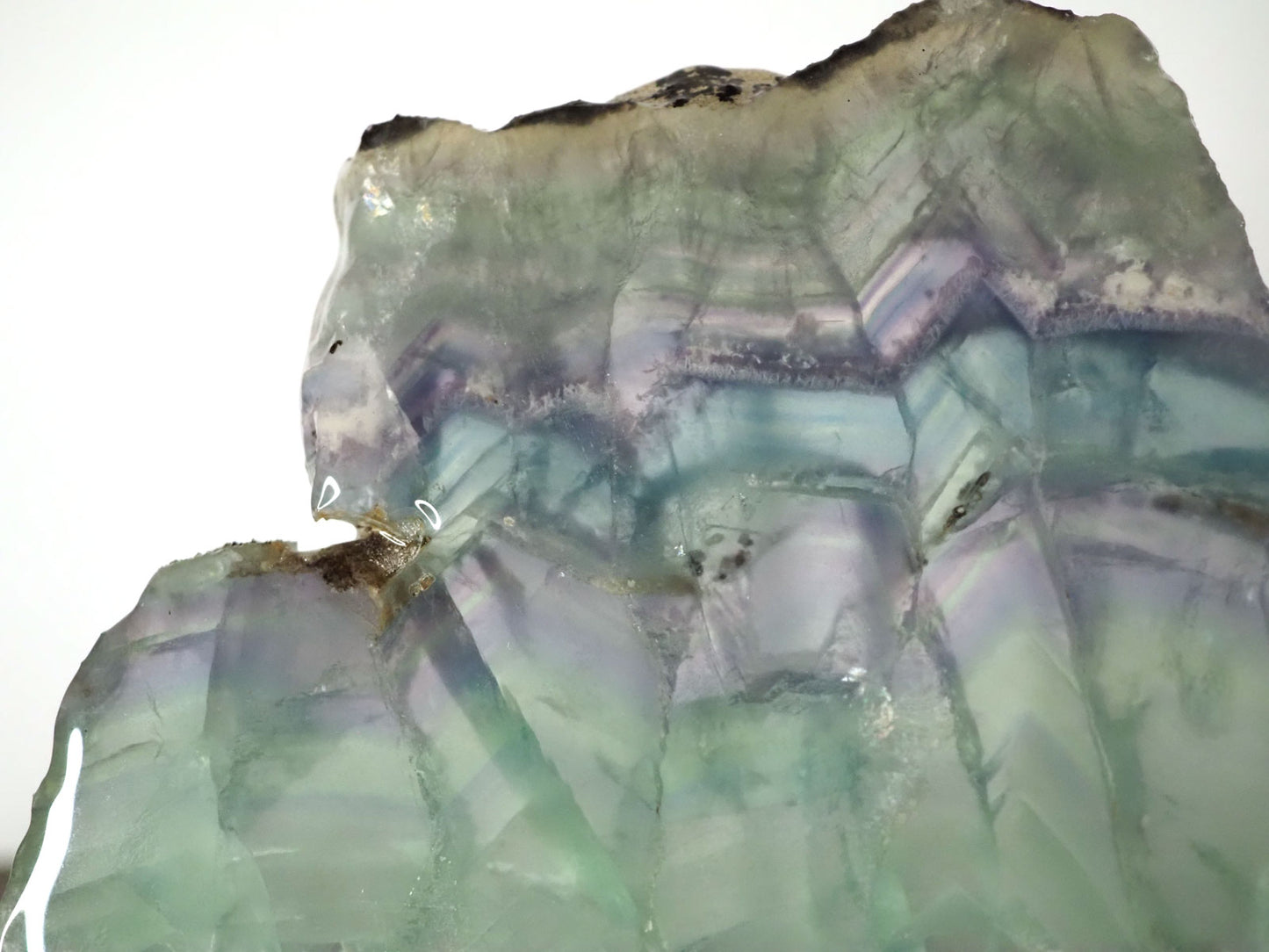 7" x 7" pastel Rainbow Fluorite slab sitting on included white metal stand - Closeup