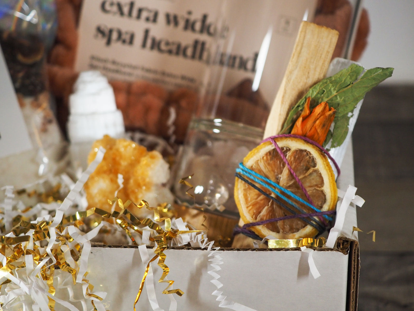 An example of the REVITALIZE gift box, showing the citrus, palo santo, and satin spar selenite bundle