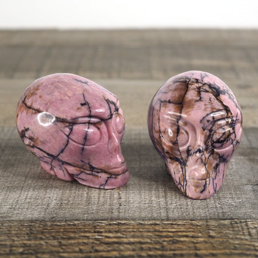 2 Hand-carved Rhodonite Alien Heads measuring about 2.25"