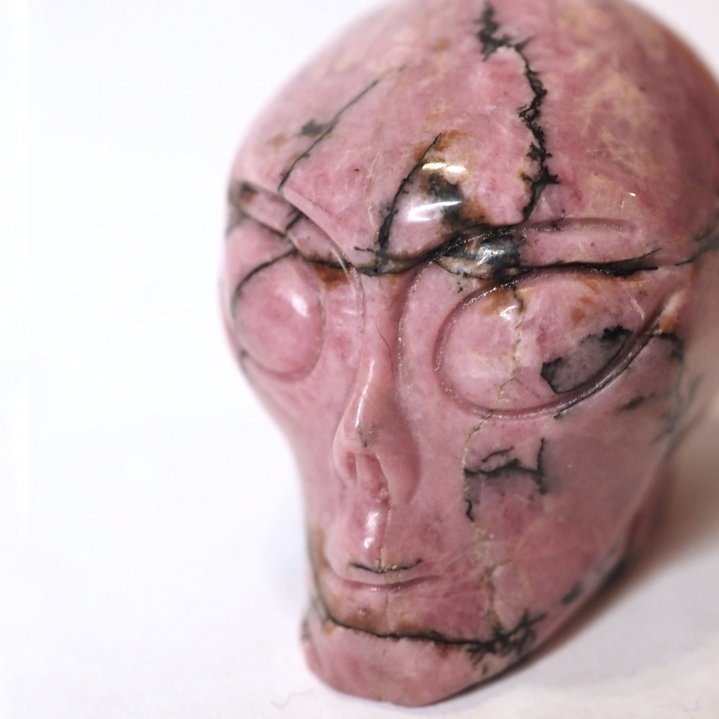 Hand-carved Rhodonite Alien Head measuring about 2.25" - Closeup