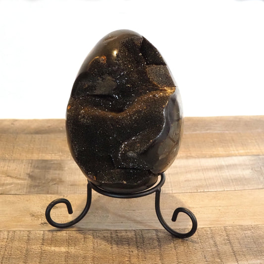 XL 7.25" tall Septarian Dragon Egg with Black Druzy, shown on its included wrought iron stand