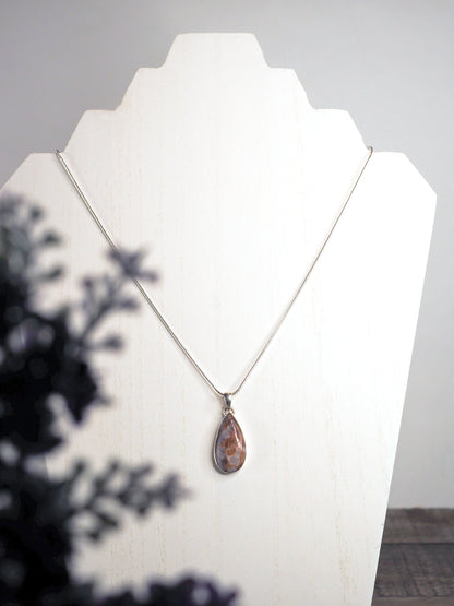 Pear-shaped Unicorn Stone Pendant hanging on a silver chain