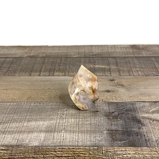 This sculpted flower agate flame with is about 2.5" tall and 1.5" wide at its base with beautiful blue agate inclusions. - Video
